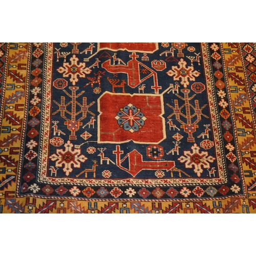 105 - An Afghan Shirvan rug, blue ground with three red central medallions divided by stylized birds and f... 