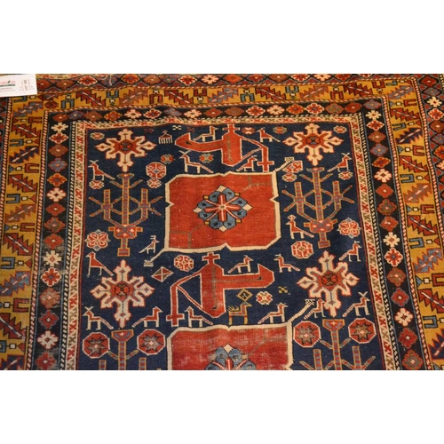 105 - An Afghan Shirvan rug, blue ground with three red central medallions divided by stylized birds and f... 