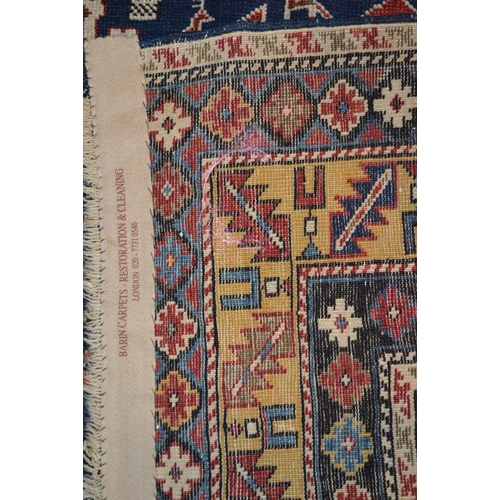 105 - An Afghan Shirvan rug, blue ground with three red central medallions divided by stylized birds and f... 