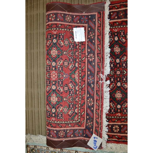 98 - A Persian Hosseinabad runner, red ground, geometric design, fringed and bordered, 772cm x 70cm