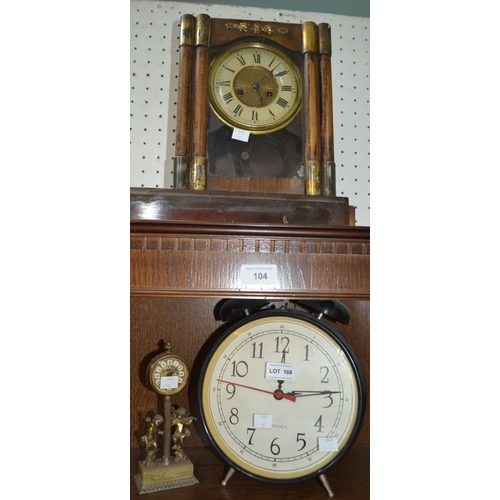 168 - An oversized alarm clock, together with a small brass Estyma clock & another