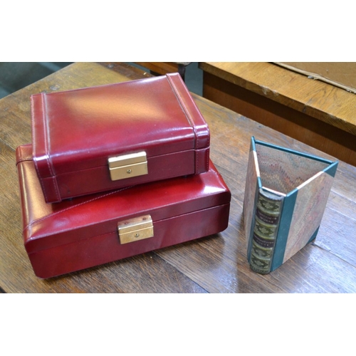 181 - Two unused red leather jewellery boxes by Nina Philipp and a novelty 'book' pen tidy