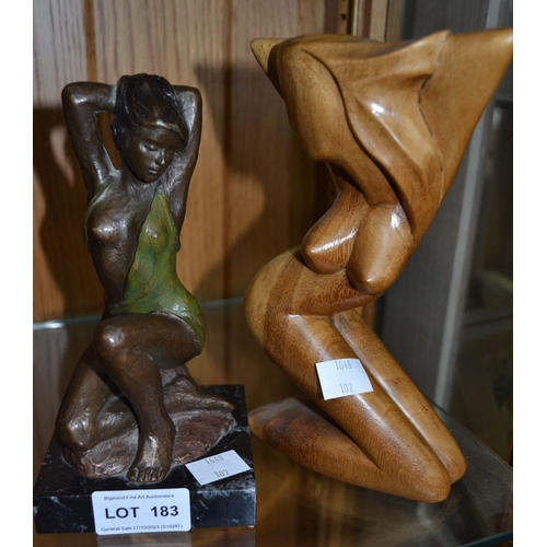 183 - A semi-nude bronze sculpture of a seated lady initialled AP, together with a similar wooden example