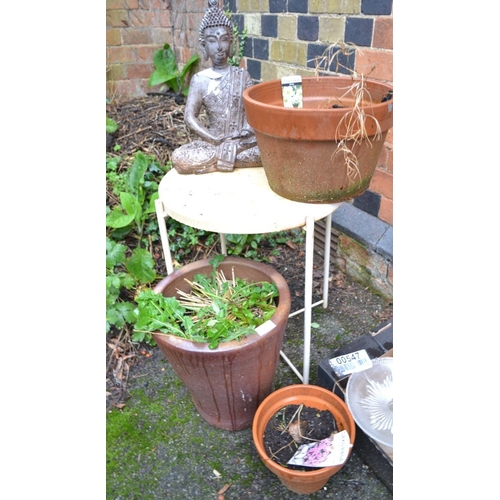 401 - A round metal outside coffee table, a Buddha statue & a good quantity of garden pots