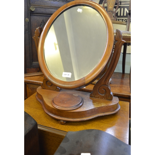 85 - A two-tier oak tea trolley and a Victorian dressing table mirror