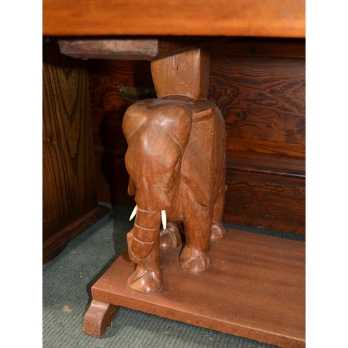 96 - An African two-tier occasional table, elephant supports