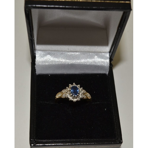 23 - A sapphire and diamond ring, set in a 9ct gold band, ring size M