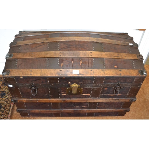 331 - A wooden banded dome top travel trunk, with carrying handles