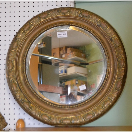 112 - A bevel edged brass framed circular mirror