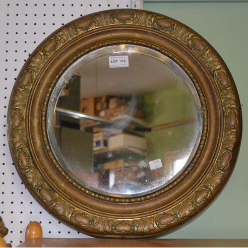 112 - A bevel edged brass framed circular mirror