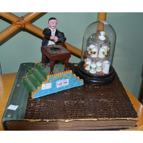 116 - A painted cast iron magician money bank, together with 78rpm records and floral china thimbles