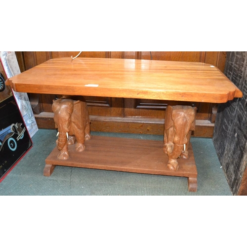 172 - An African Ghana mahogany two-tier occasional table, elephant supports