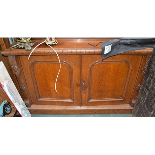 175 - An oak open bookcase on cupboard base