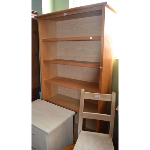 181 - A modern light oak bookcase, having two drawers at base