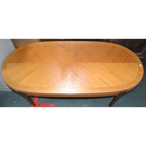 187 - A modern oval topped coffee table having a decorative veneer top