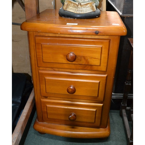 65 - A pine three drawer bedside cupboard