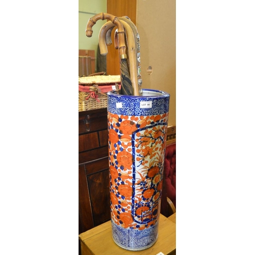 86 - An Imari design pottery cylindrical stick stand, with various sticks