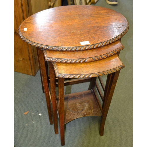 87 - An oak nest of three tables with rope carved edge