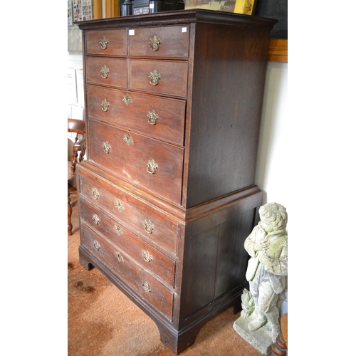 378 - A late George III oak chest on chest, the top section four small over two long drawers. The base fit... 