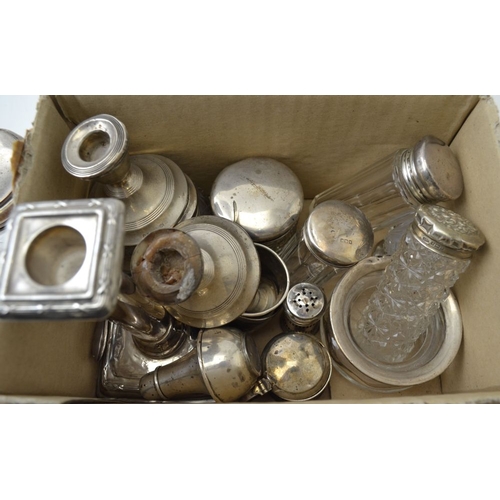 128 - A quantity of assorted silver items, includes, candlesticks, silver lidded cut glass jars, a caddy s... 