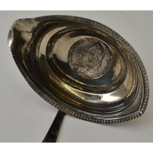 1 - An 18th century silver punch ladle inset with Lima half crown, 1746, with twisted whale bone handle