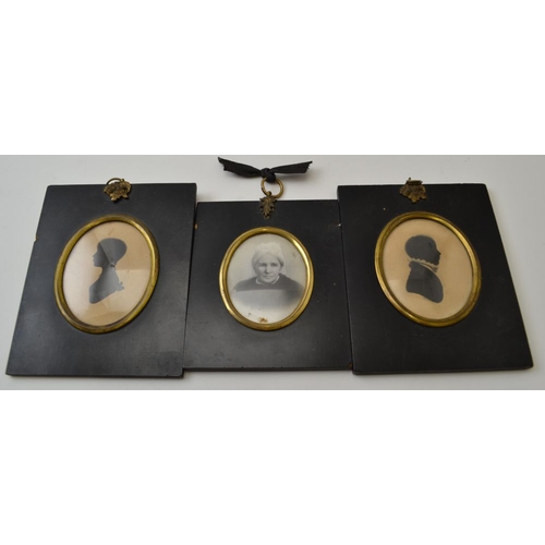 113 - A pair of 19th century silhouettes, oval mounted within ebonised frames with gilt brass floral ring ... 