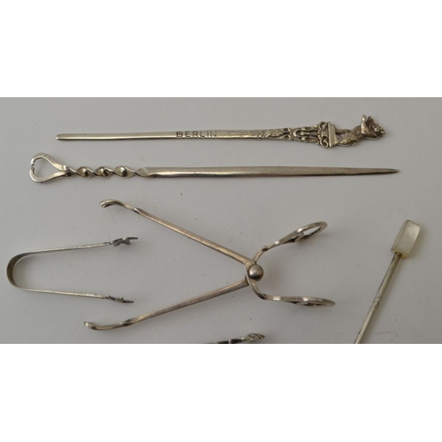 15 - Three silver tongs, two silver skewers, two silver pickle forks, four salt spoons, weight: 93g (incl... 