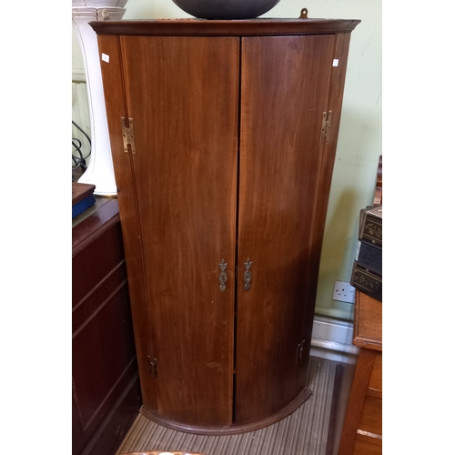 193 - Large 20th century bow front corner cupboard