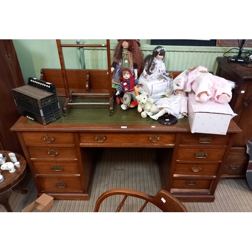 202 - Large 20th century oak desk with decorative rear upstand and skiver insert top