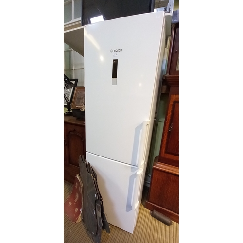 209 - A Bosch upright fridge freezer in white