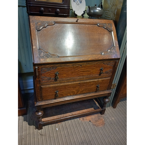 213 - An Edwardian oak fall front bureau, green leather inset writing surface, fitted interior, over two d... 