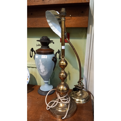 219 - Two brass table lamps with the base of an oil lamp