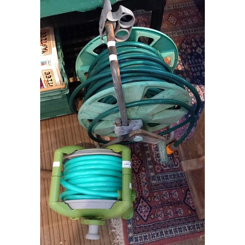 239 - Two garden hoses on reels