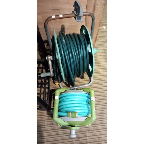 239 - Two garden hoses on reels