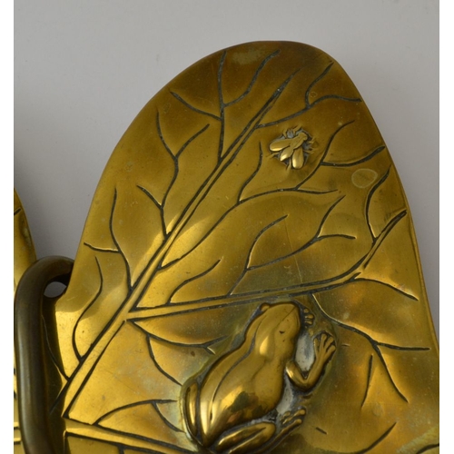 71 - A pair of Arts and Crafts brass wall sconces of Lily pad design, each embossed with a frog and insec... 