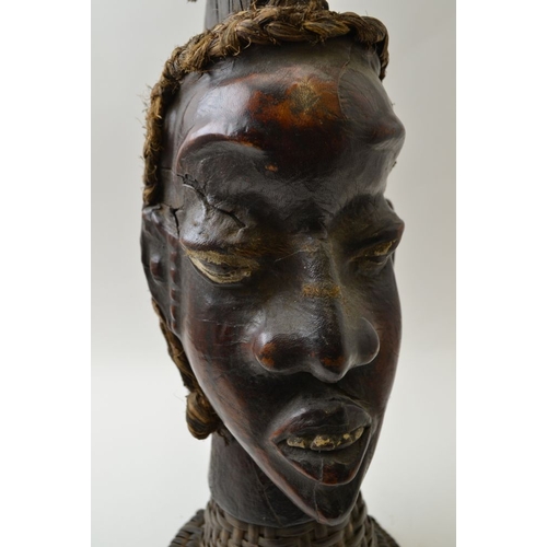 74 - An African sculptural head, mixed media, including leather and straw raised upon a plaited cane neck... 