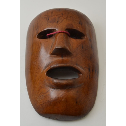 75 - Three items of treen, includes a carved hardwood mask, possibly Japanese, a carved wood figure of an... 