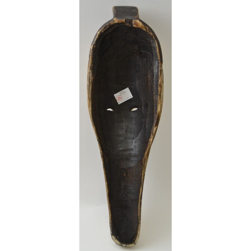 77 - A carved wood African mask, elongated form, remains of partial painting, 32cm