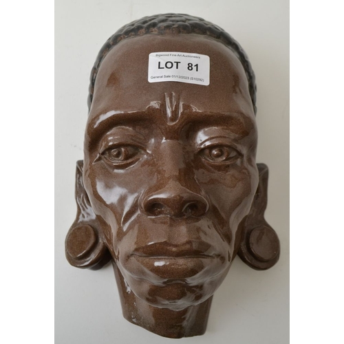 81 - A glazed terracotta wall mounting mask, 25cm high