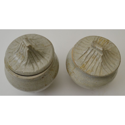 96 - A pair of Chinese ceramic Sung style covered jars, the covers modelled in roof design, the tallest 1... 