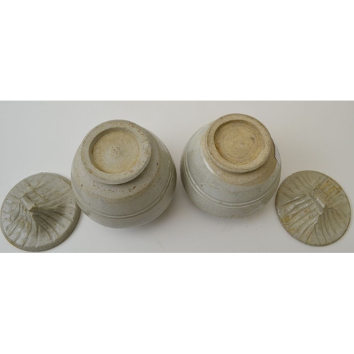 96 - A pair of Chinese ceramic Sung style covered jars, the covers modelled in roof design, the tallest 1... 