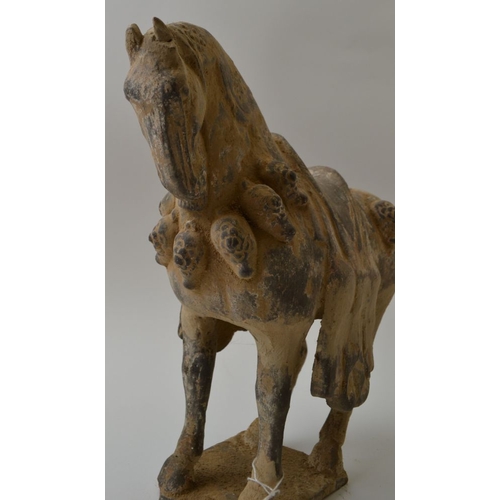 99 - A Chinese pottery model of a saddled horse, in the Wei Dynasty style, standing four square on a rect... 