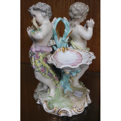 108 - A Continental porcelain table centre piece, in the form of two putti, with scallop salts, factory ma... 