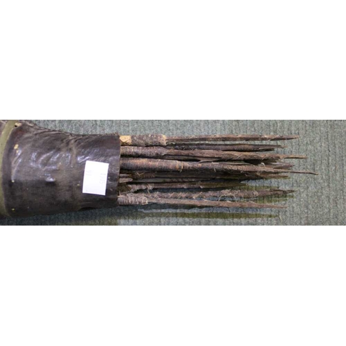 13 - A hardwood long bow, and leather quiver of barbed arrows, considered to be Far Eastern Islands