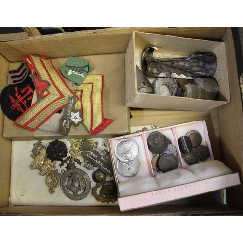 35 - A collection of cap badges, wartime relics, cloth insignia coins etc