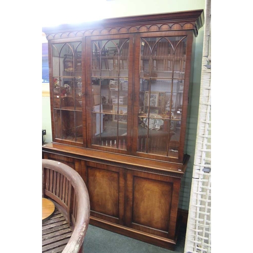 69 - A reproduction mahogany library bookcase, having three astragal glazed doors, over three panel doors... 