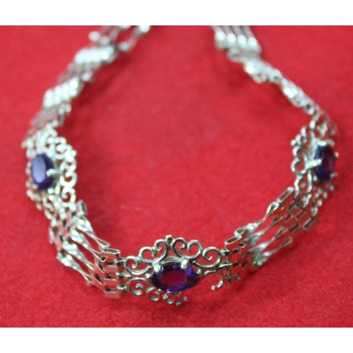 268 - A 9ct gold gate link bracelet, purple stone set, fitted 9ct gold padlock clasp gross weight 7.9g