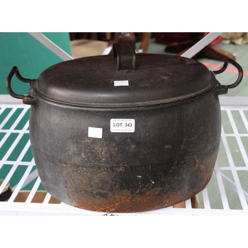 343 - A large two handled cast iron cooking pot