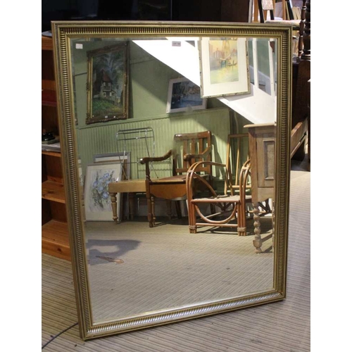 104 - A large bevel edged gilt framed wall mirror