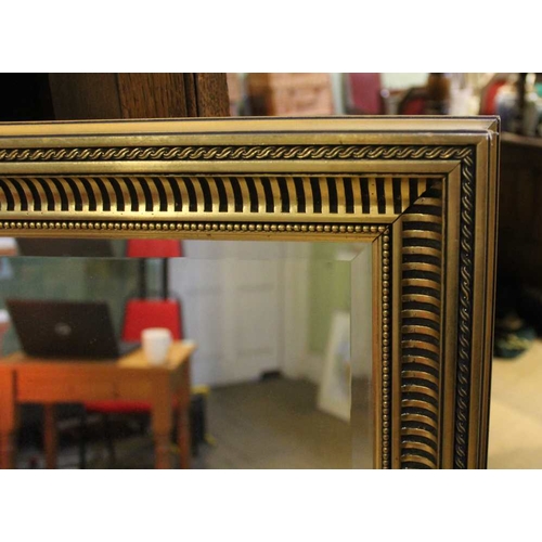 104 - A large bevel edged gilt framed wall mirror